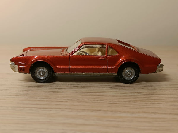 276 Oldsmobile Toronado in metallic red