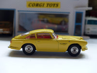 218 Aston Martin in yellow with fixed wheels and open vent