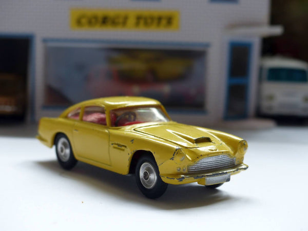 218 Aston Martin in yellow with fixed wheels and open vent