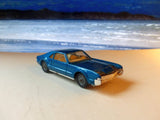 264 Oldsmobile Toronado in bright blue-turquoise with tow bar